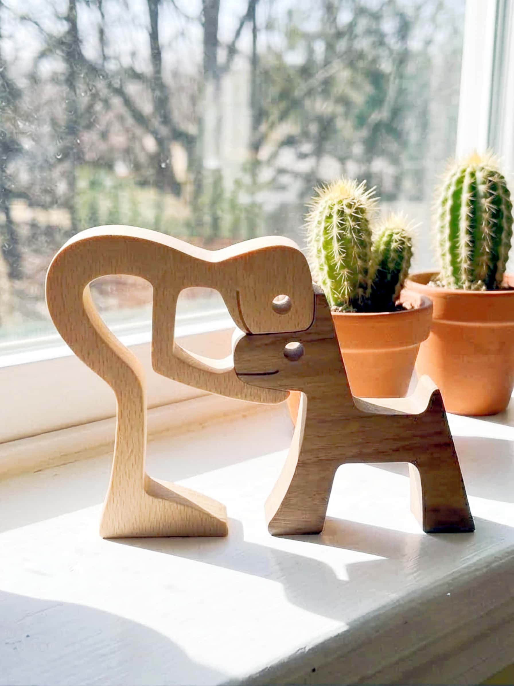 Wooden sculpture on a windowsilll