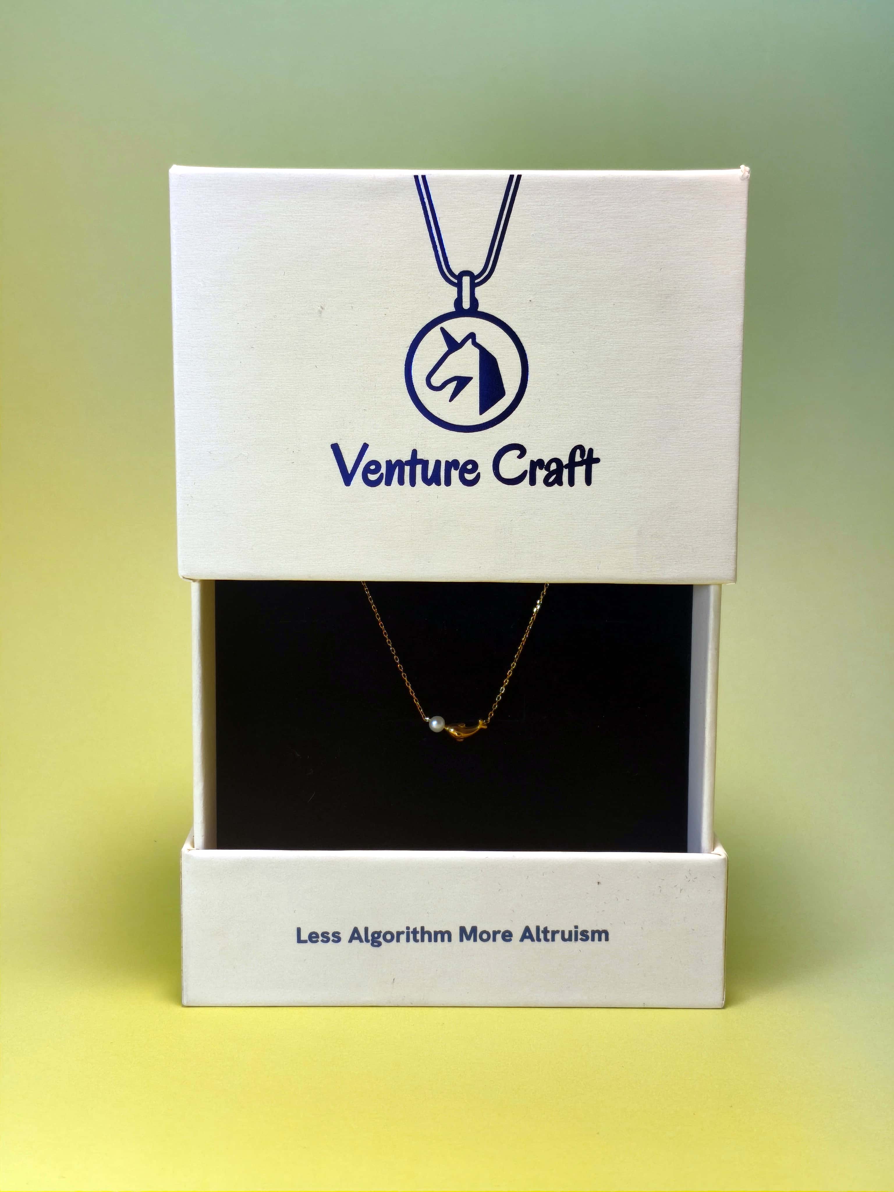 Dolphin pearl necklace in a 'Venture Craft' box with a gradient background
