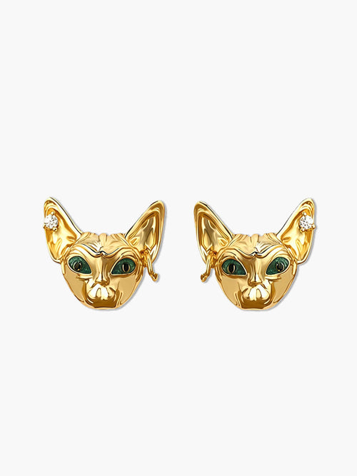 Gold cat earrings with green eyes on a white background